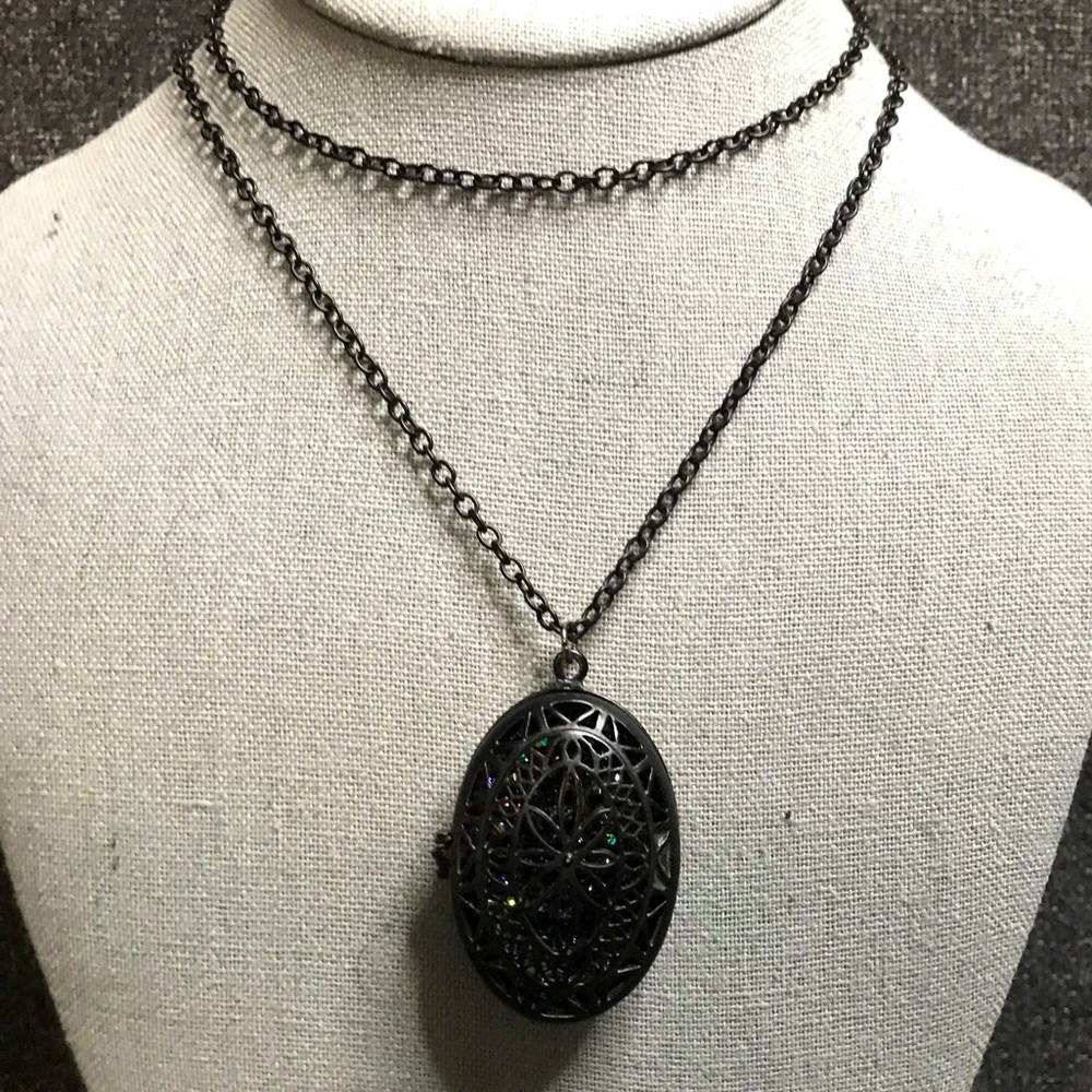 Black locket with gems inside.